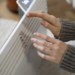 close-up-person-near-heater